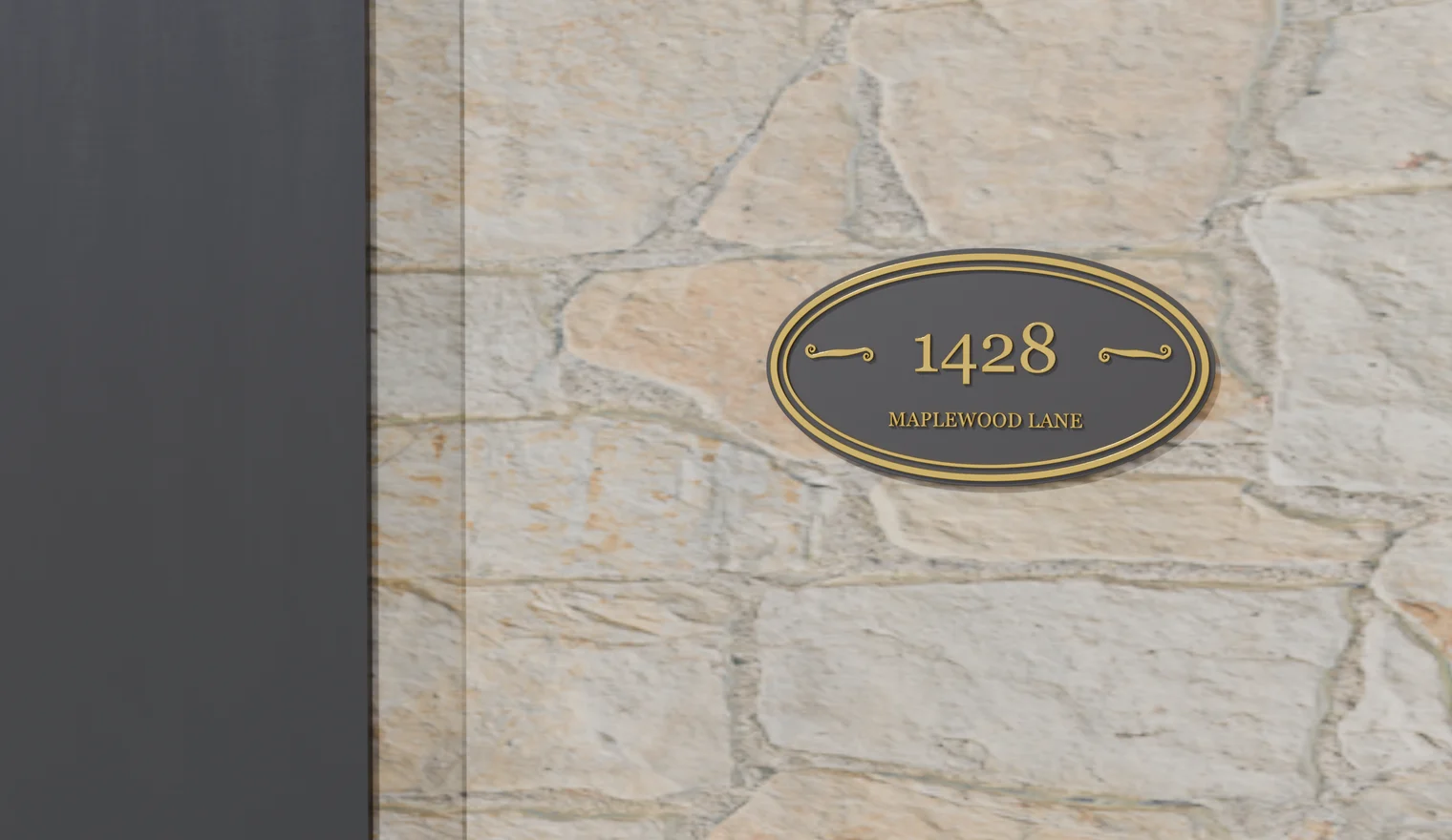 A PlateForge Classic Oval nameplate — 1428 Maplewood Lane — on a stone entrance wall beside a deep-green front door, in golden-hour light